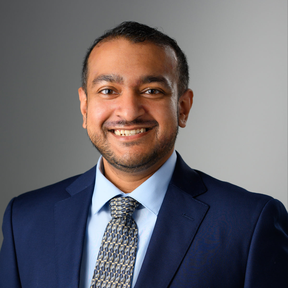 Subhan, the Owner of Zail's Vault, in professional attire