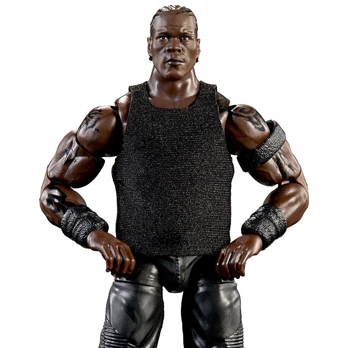 A muscular male action figure or collectible character posed with hands on hips, wearing a black sleeveless textured top, black pants, and black wrist wraps, photographed against a plain white background.