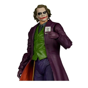 Action figure of a character in a purple coat and green shirt holding a card on a white background